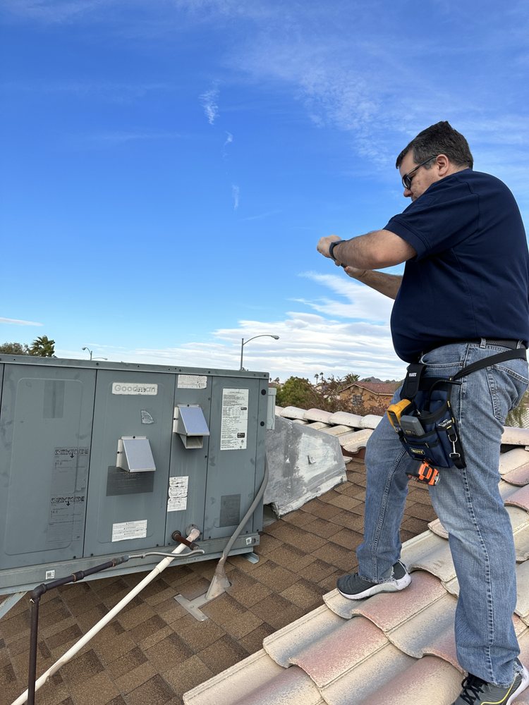 NV Inspection Services home inspector examining rooftop equipment